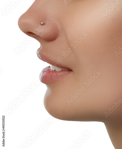 Obraz na plátně Young woman with nose piercing on white background, closeup