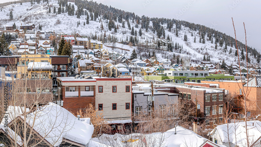 Pano Colorful houses and buildings on a snow-covered hill at Park City in Utah