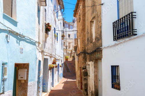 Narrow streets of Chelva, picturesque and brightly painted houses, on a sunny day. © MiguelAngel