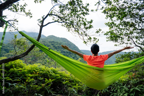 Relaxing in hammock in summer tropical rainforest