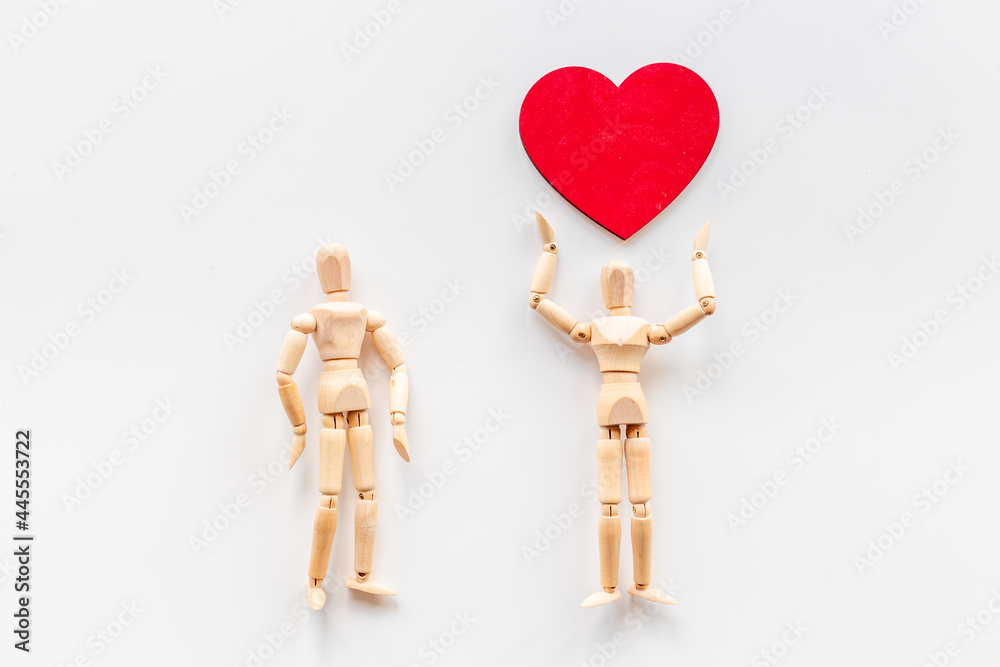 Couple of wooden mannequin figures with heart. Love and dating concept Couple of wooden mannequin figures with heart. Love and dating concept