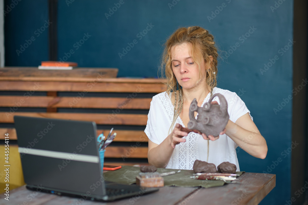artisan pottery tutor in art studio. woman ceramist teaches an online lesson or leads a video master class on creating ceramic products artisan pottery tutor in art studio. woman ceramist teaches an online lesson or leads a video master class on creating ceramic products