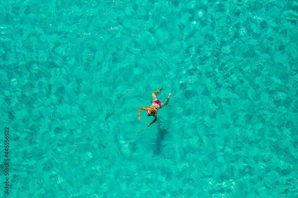 Aerial view of a girl floating in the turquoise sea of the Sakarun beach, Adriatic Sea, Croatia Aerial view of a girl floating in the turquoise sea of the Sakarun beach, Adriatic Sea, Croatia