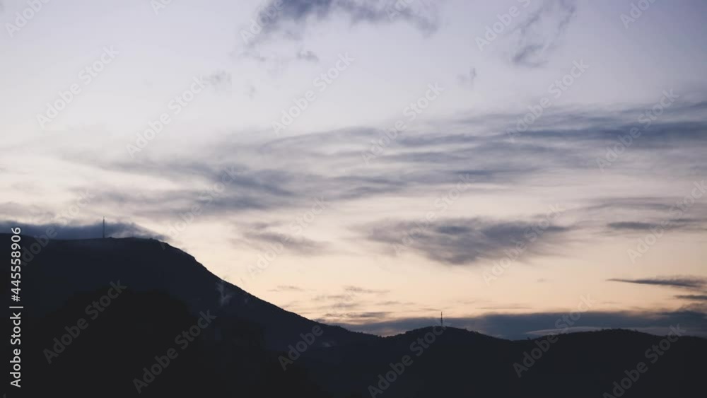 timelapse of day turning to dusk and clouds rolling over the mountains and thick vegetation shot in Tasmania, Australia timelapse of day turning to dusk and clouds rolling over the mountains and thick vegetation shot in Tasmania, Australia