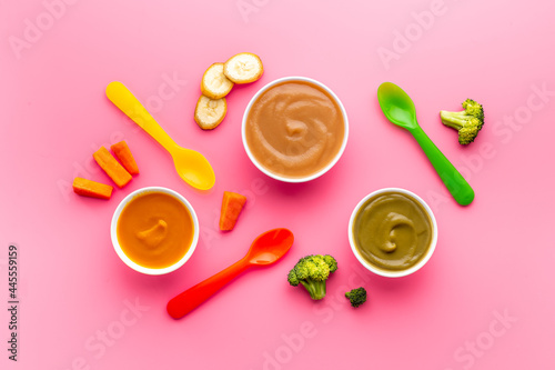 Set of bowls with baby food with fruits and vegetables. Kid feeding, top view