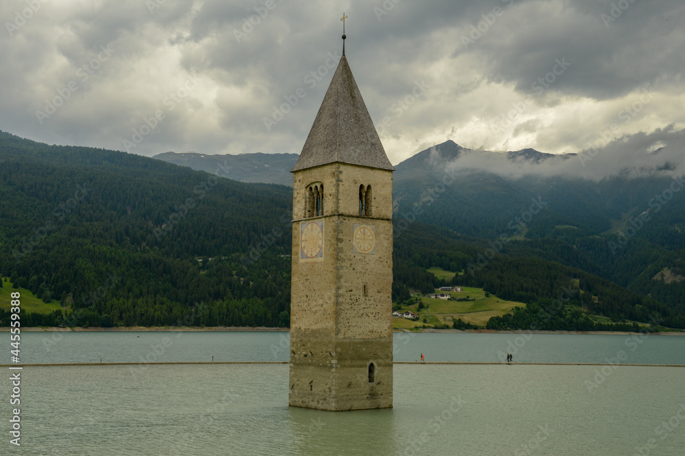 Bell tower submerged in the waters of the dam at Resia in Italy