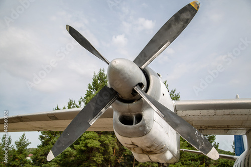 propeller and airplane wing against cloudy sky