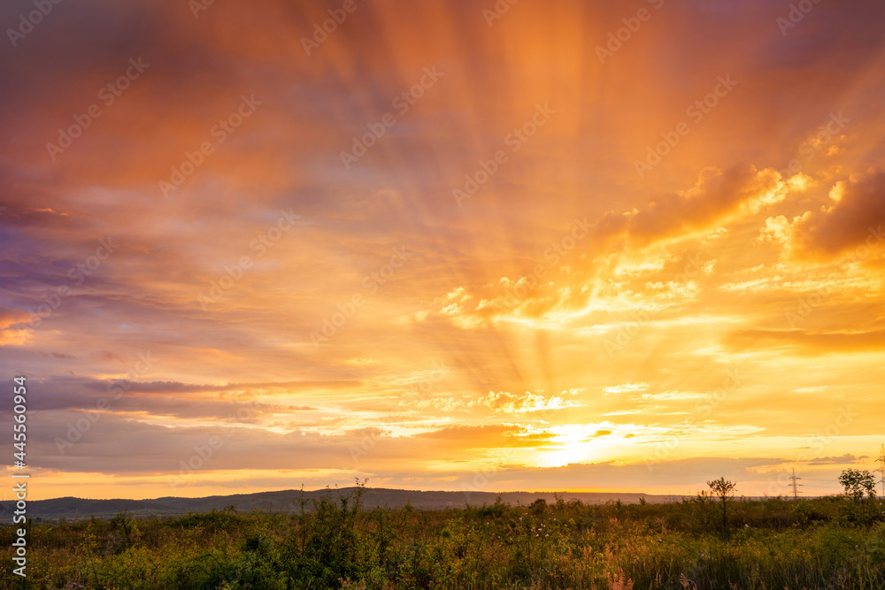 Majestic summer sunset with colorful clouds and sunrays Majestic summer sunset with colorful clouds and sunrays