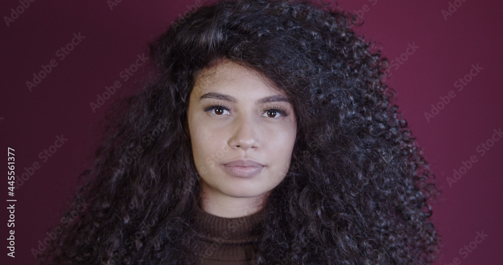 Smiling young latin afro woman. Joy, positive and love. Beautiful african-style hair.