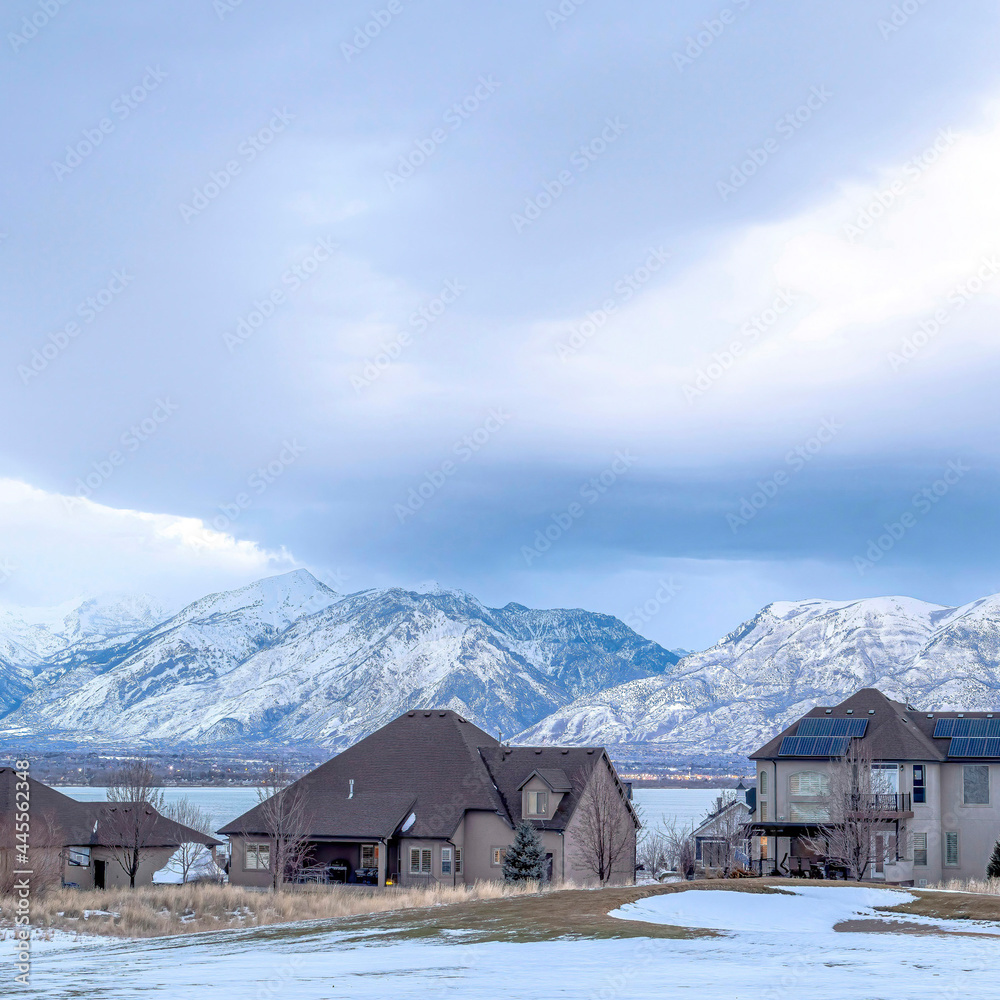 Square Lake front homes on a snowy neighborhood setting with Wasatch Mountains view