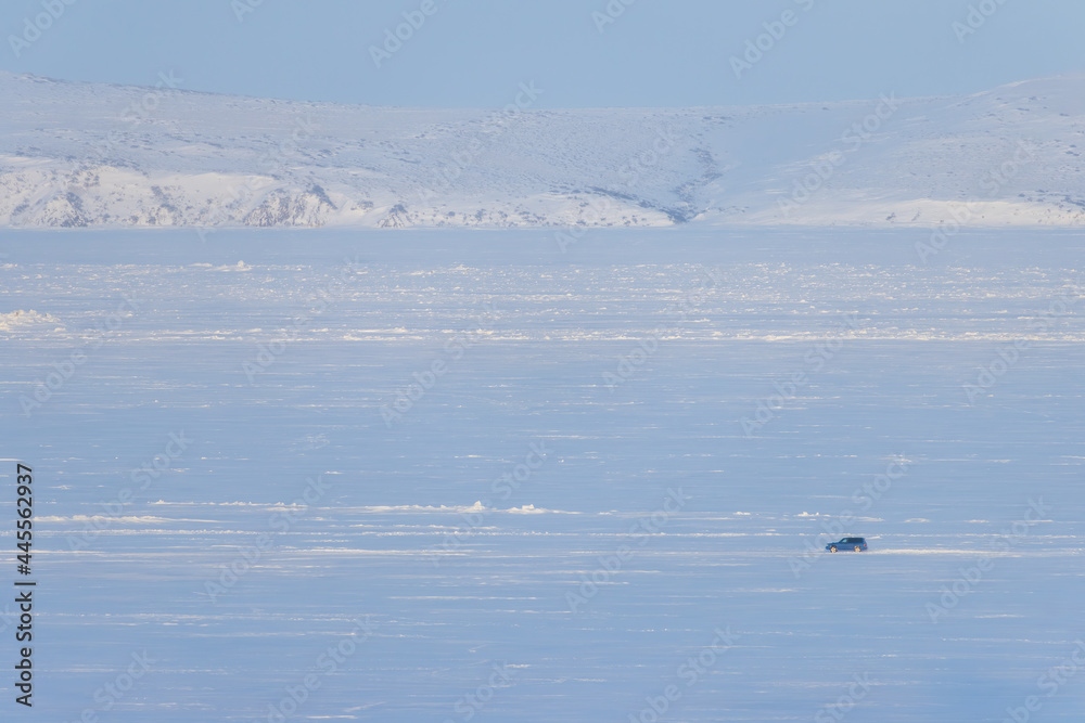 Winter Arctic landscape. The car is driving on snow and ice. Winter ice road along the frozen river. Extreme travel and car trips in the Arctic. Anadyr estuary, Chukotka, Siberia, Far North of Russia. Winter Arctic landscape. The car is driving on snow and ice. Winter ice road along the frozen river. Extreme travel and car trips in the Arctic. Anadyr estuary, Chukotka, Siberia, Far North of Russia.