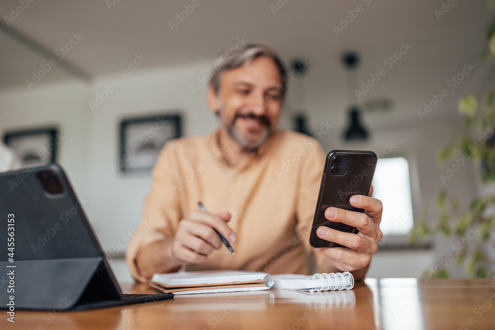 Adult man, using the phone to help with his work. Adult man, using the phone to help with his work.