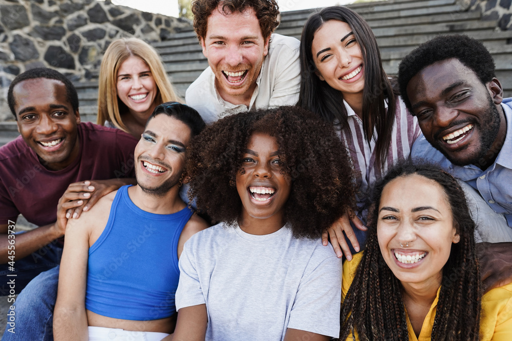 Young diverse people having fun outdoor laughing together - Diversity concept - Main focus on african girl face Young diverse people having fun outdoor laughing together - Diversity concept - Main focus on african girl face
