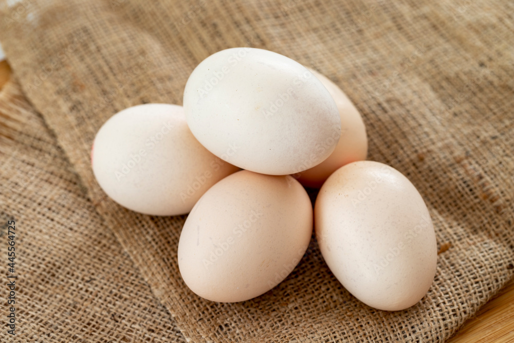 Chicken Egg. organic eggs on burlap fabric Chicken Egg. organic eggs on burlap fabric