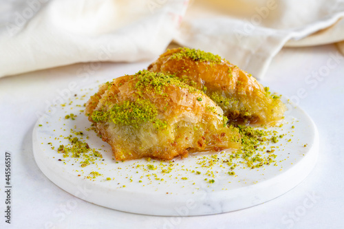 Sobiyet baklava with pistachio on a white wooden background. Baklava on a marble floor. Close up