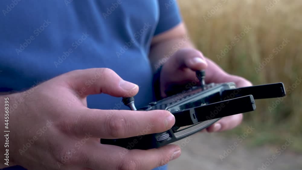 The guy controls the drones. remote control of the drone in hands. The guy controls the drones. remote control of the drone in hands.