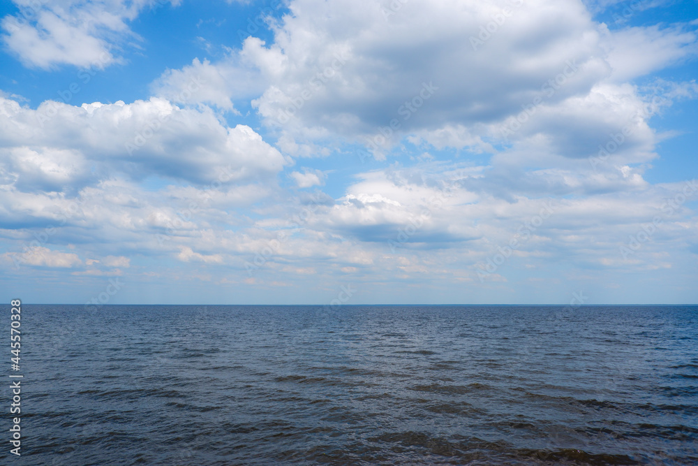 Scenery. View of the big river and the sky with clouds on a sunny day.