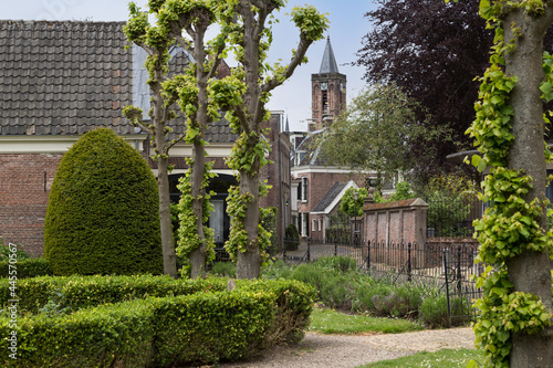 Garden and street overlooking the historic reformed church in the center of Loenen, Netherlands. photo