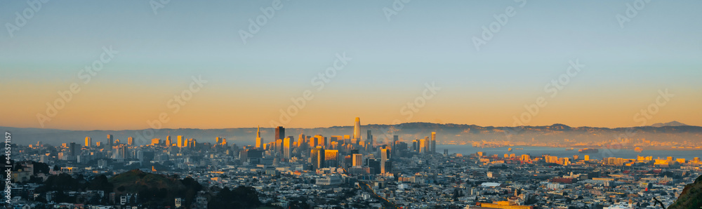 A picturesque panorama of the city of San Francisco at a bright beautiful sunset from Twin Peaks hill.