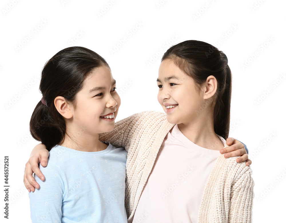 Cute Asian sisters on white background Cute Asian sisters on white background