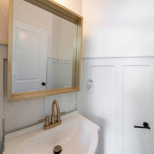 Square frame Interior of a powder room with a view of sink and mirror photo