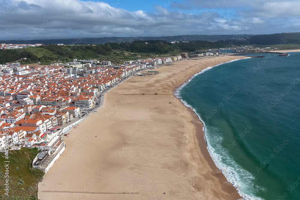Fantastic view of the beach and town of Nazaré and the town from the viewpoint of the touristic old town of Nazaré, atlantic ocean and sky