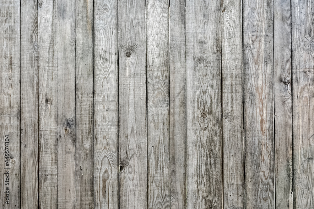 The texture of an old weathered wooden fence. Pattern and natural wood background. The texture of an old weathered wooden fence. Pattern and natural wood background.