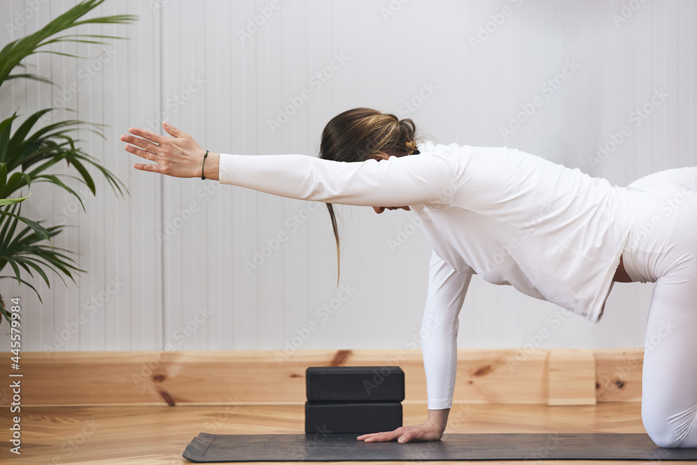 partial image of woman doing yoga without a facerenocible in a nice environment