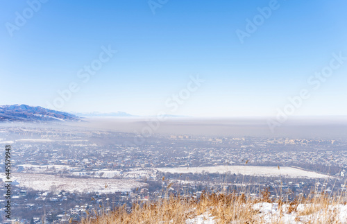 View of Almaty city and smog over it. Almaty, Kazakhstan.