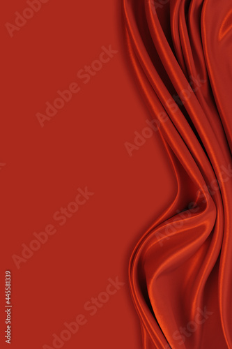 Beautiful elegant wavy dark red satin silk luxury cloth fabric texture with monochrome background design. Copy space