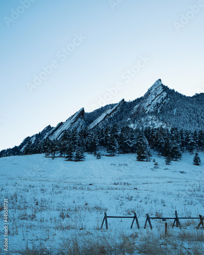 boulder flatirons landscape covered in snow during a sunny winter day photo