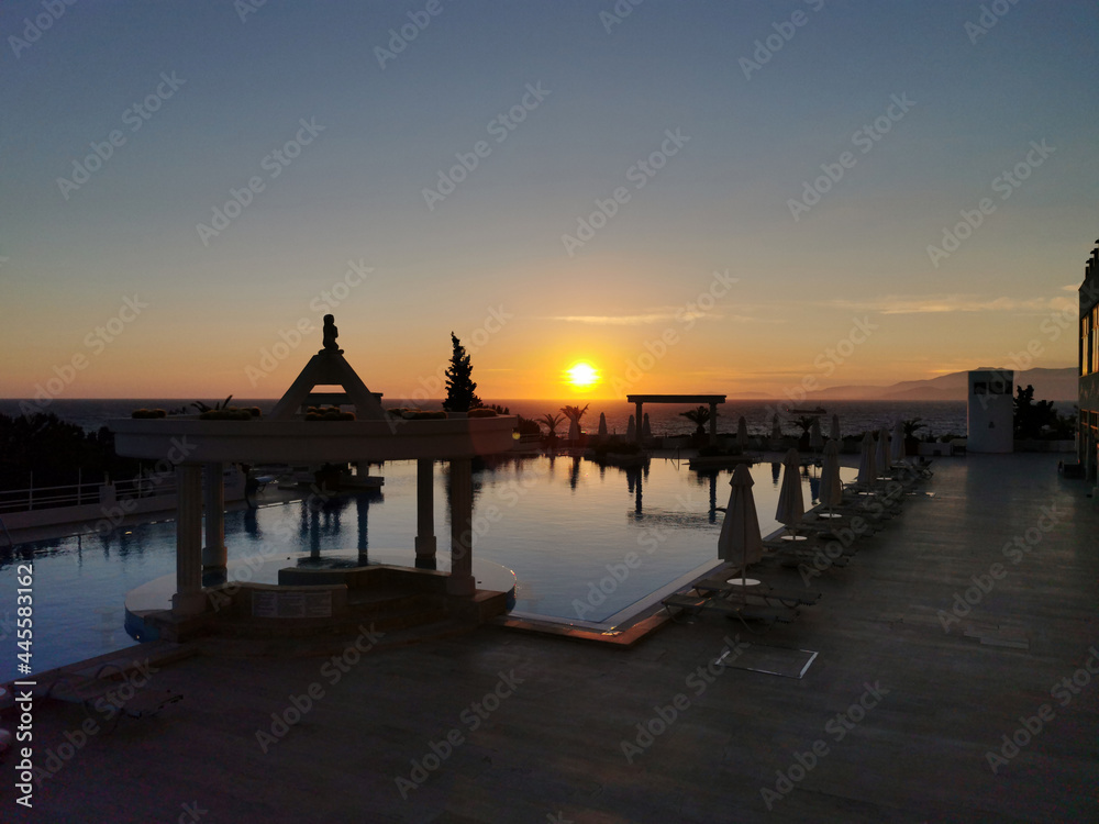 Beautiful sunset over the empty pool and the sea. The Aegean sea. Turkey, Kusadasi. Beautiful sunset over the empty pool and the sea. The Aegean sea. Turkey, Kusadasi.
