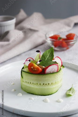 Fototapeta Naklejka Na Ścianę i Meble -  Vegetable appetizer on a plate with drops of sauce and feta cheese
