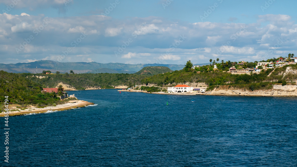 View of the entrance to the Santiago de Cuba bay. Some colorful buildings and coral beach 