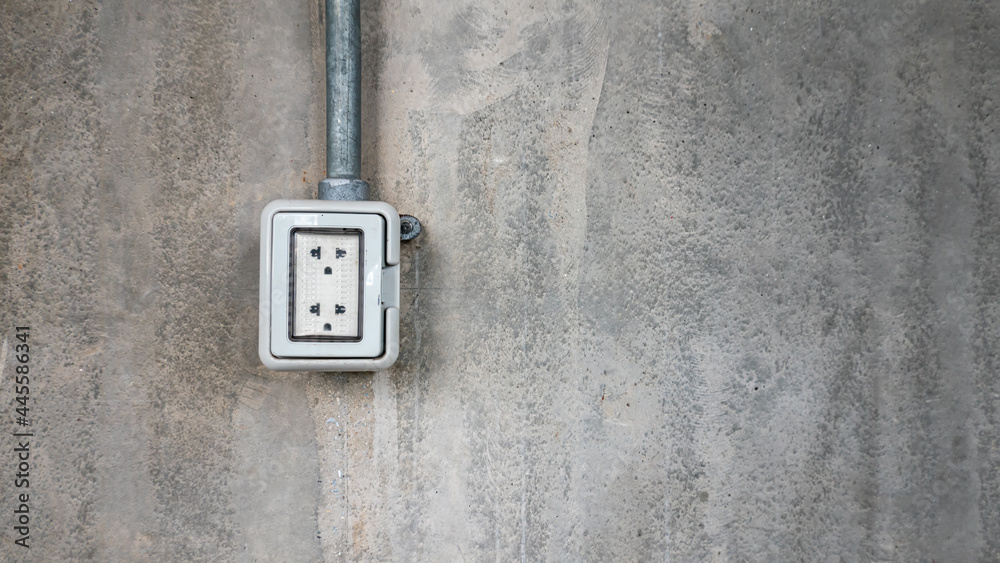 electric plug on cement wall.