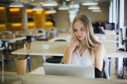 Beautiful young woman working using computer laptop concentrated and smiling