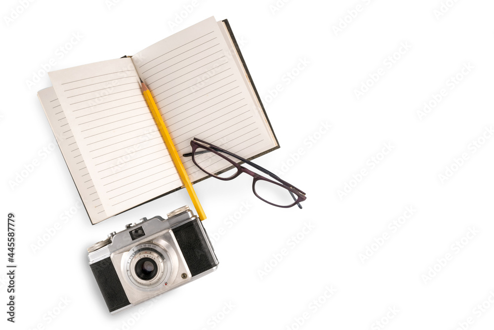 Retro camera with lined notebook and yellow pencil and glasses isolated on white, travel concept, copy space Retro camera with lined notebook and yellow pencil and glasses isolated on white, travel concept, copy space