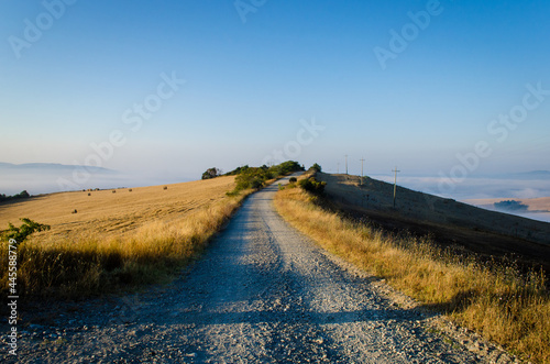 Scendendo all'alba da Radicofani verso il fondovalle lungo la Via Francigena photo