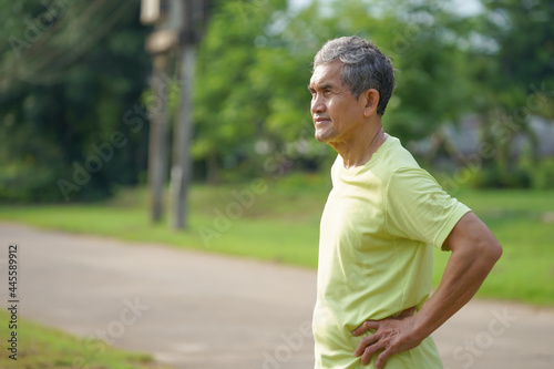 elderly retired man is standing casually after exercise in the park, concept healthcare in elderly people
