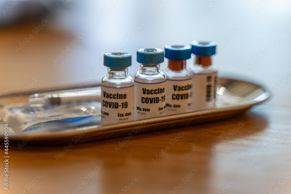 Selective focus on Vaccine bottle, Close up Coronavirus covid-19 vaccine bottle on table with syringe prepare for injection. Coronavirus infection prevention, diseases, medical care, science concept.	