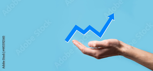Hand hold drawing on screen growing graph, arrow of positive growth icon.pointing at creative business chart with upward arrows.Financial, business growth concept.