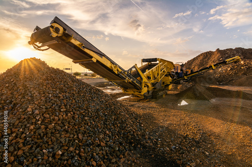 Heavy and mobile machinery in a quarry to transform stone into construction material photo