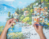 Painting for beginners, a woman draws a picture by numbers with acrylic paints on canvas artist draws a picture, painting a picture with a brush, a girl draws a picture, self-isolation, home hobby