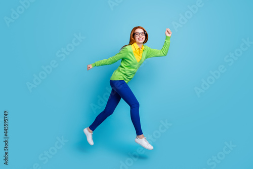 Full length body size view of nice funny cheerful girl jumping walking isolated over bright blue color background