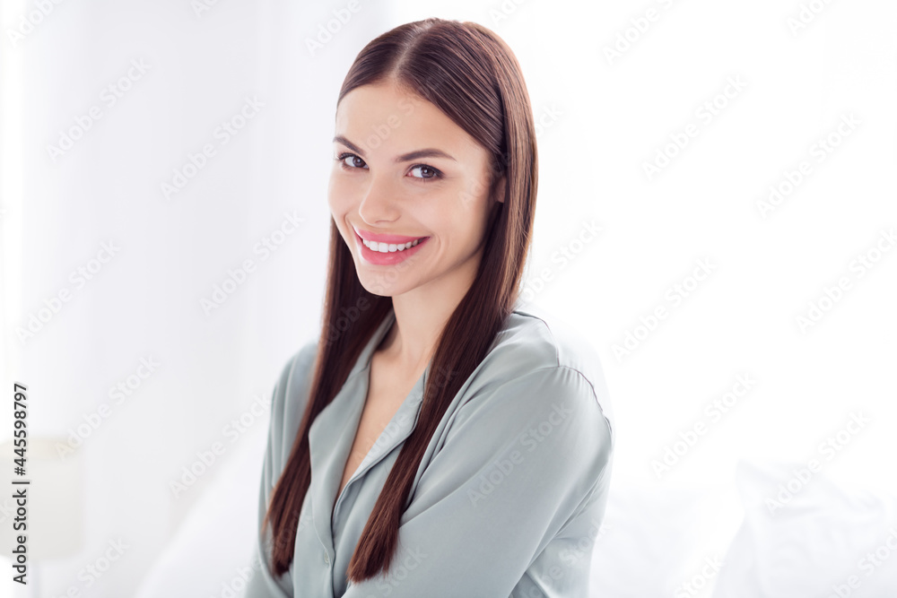 Photo of shiny charming young lady grey sleepwear smiling indoors room home house