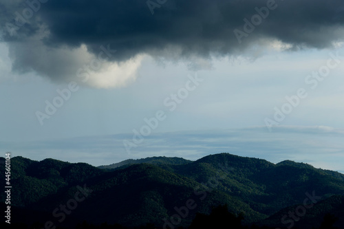 Dramatic of rain storm over the mountain range and rice fields in Thailand