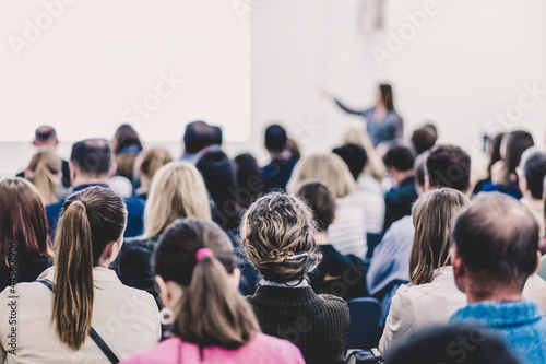 Woman giving presentation on business conference.