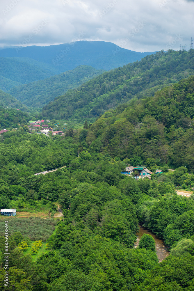 beautiful green mountain river valley and residential village