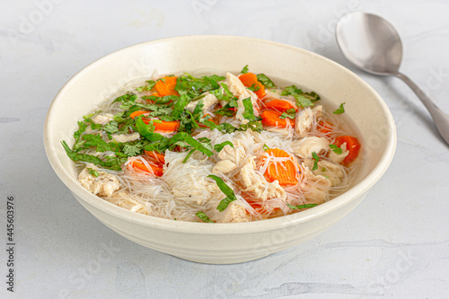 A Bowl of Fresh and Healthy Chicken Soup with a Spoon Close Up Photo