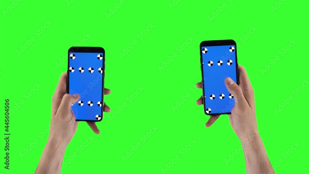 Two male hands with smartphones swipe left and right on touchscreens on alpha channel. Man slides pages on mobiles with tracking marker. Double cellphones on green screen. Gadgets on mockup background